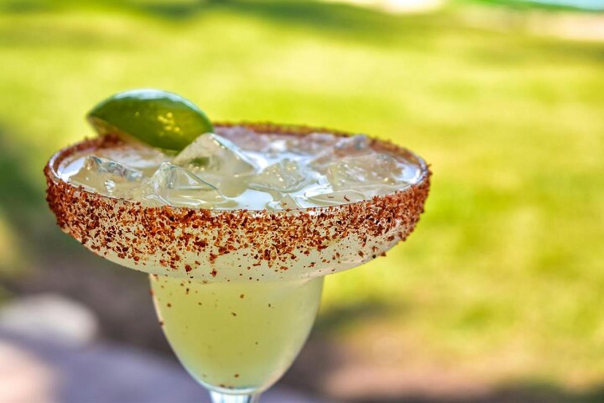 a drink with a margarita with a lime on top
