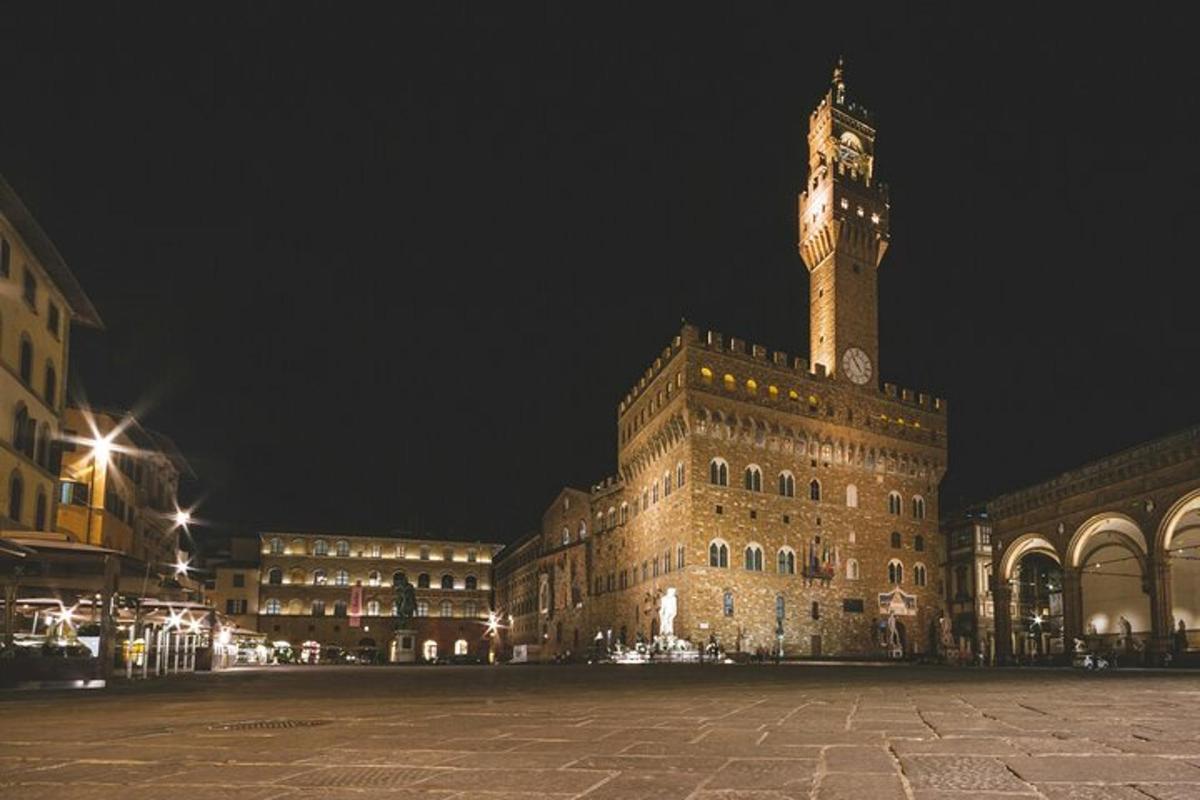 a large building with a clock tower at night