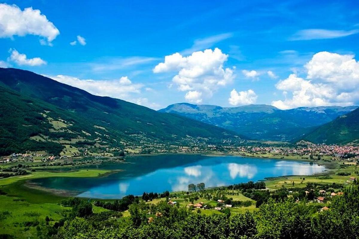 a view of a lake in a valley with mountains