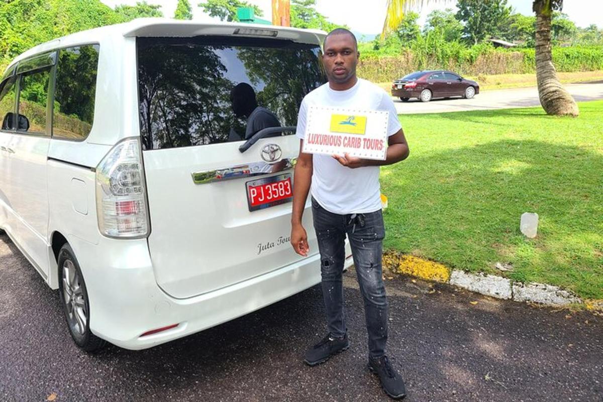 a man holding a sign in front of a white van