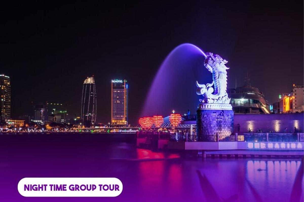 a fountain in the middle of a city at night