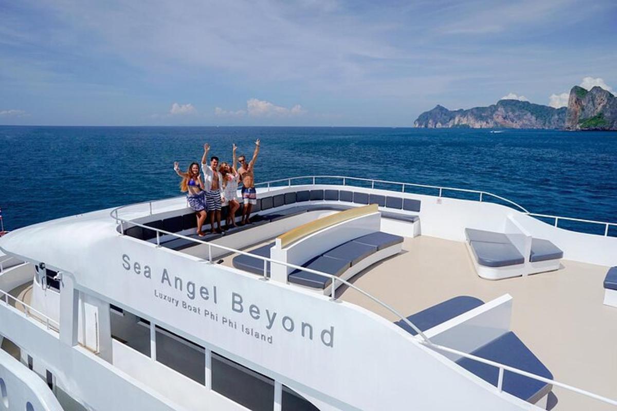 a group of people standing on the deck of a yacht