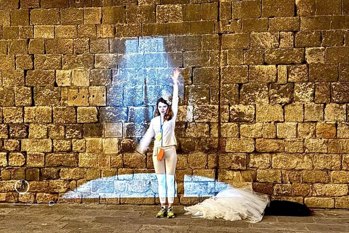 a woman standing in front of a brick wall