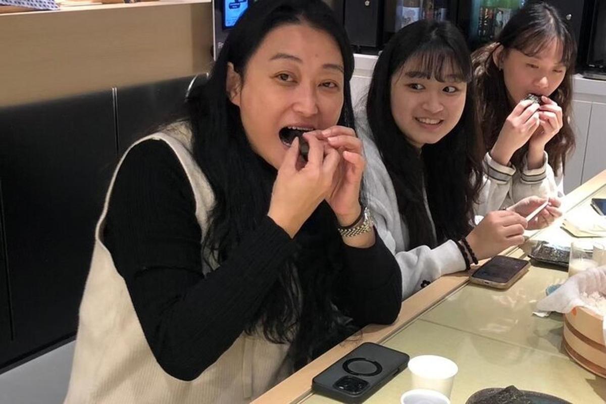 two women sitting at a table eating chocolate
