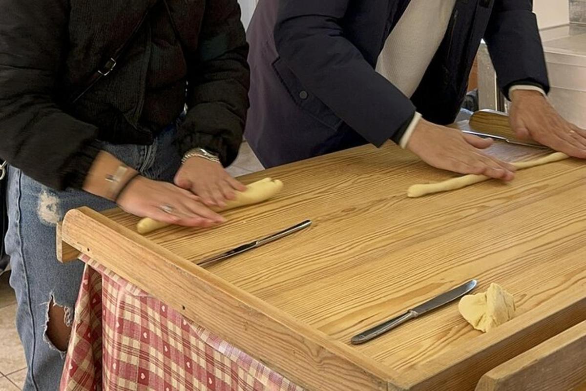 two people are preparing food on a cutting board