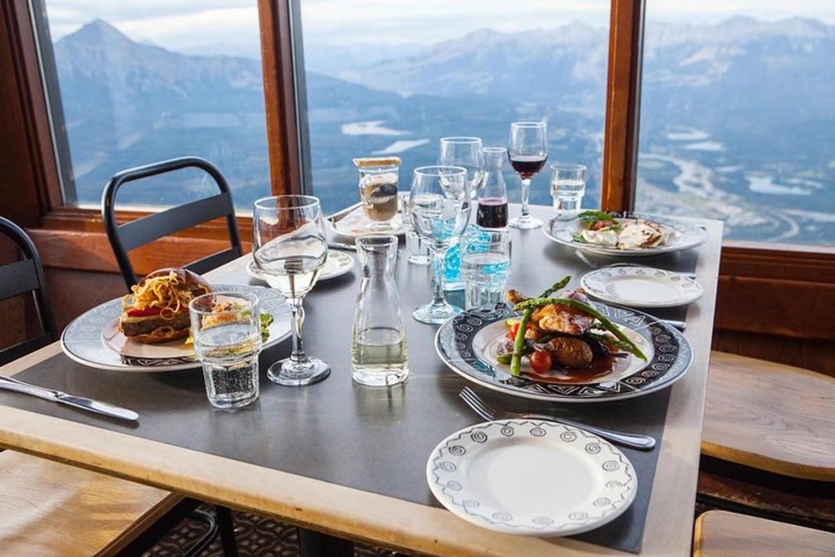 a table with plates of food and glasses of wine