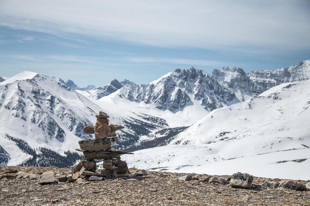 a rock sculpture on top of a snowy mountain