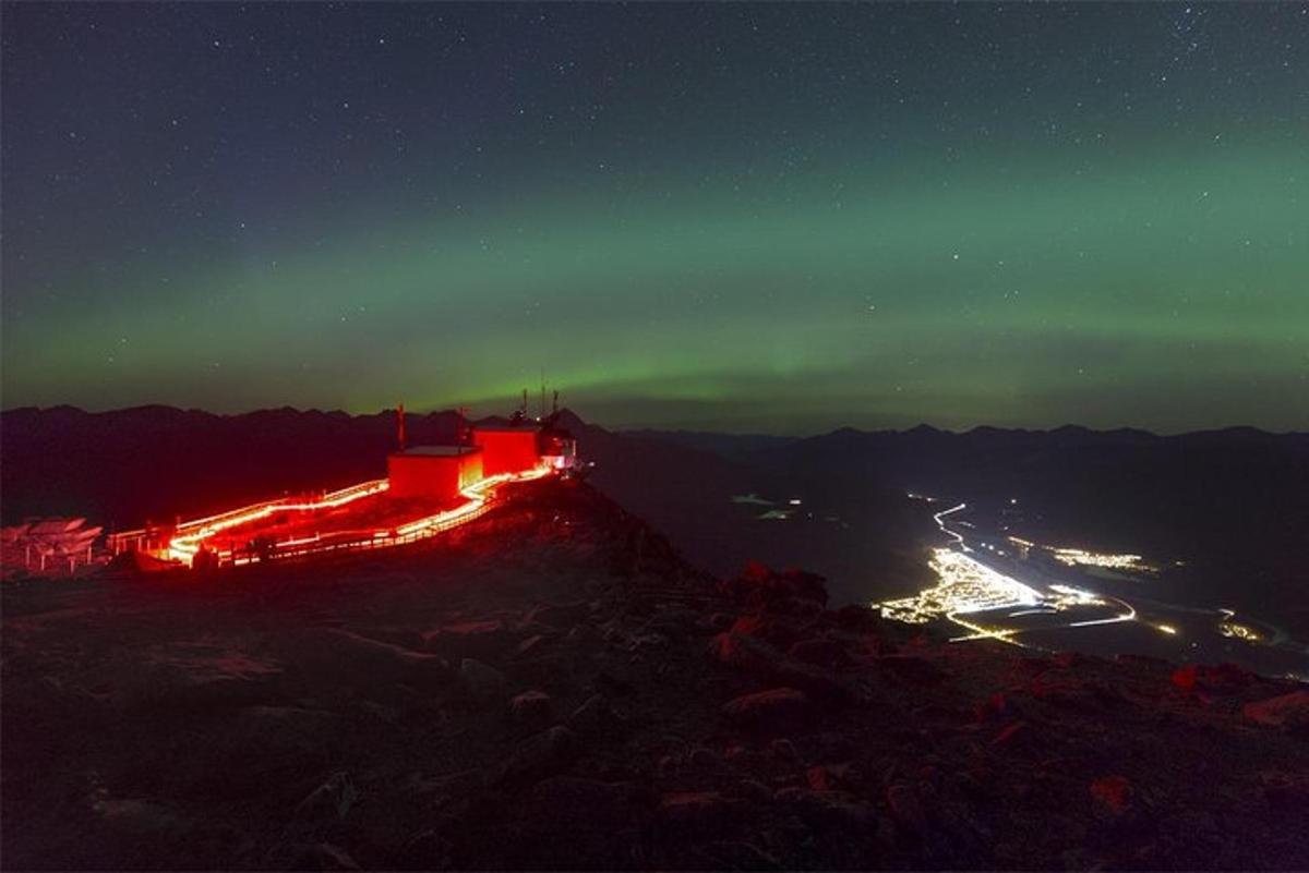 a building on top of a mountain at night