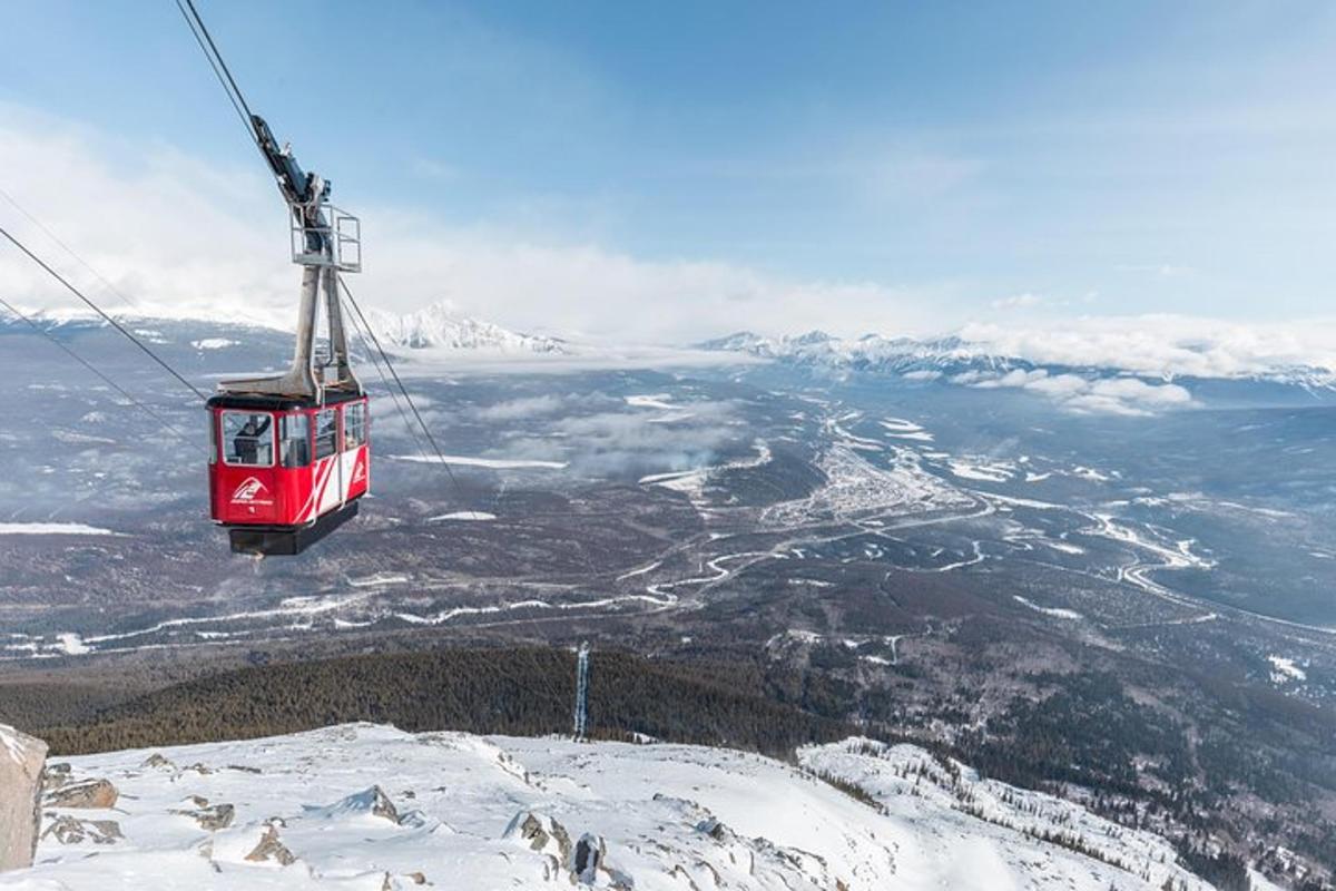a gondola flying over a snow covered mountain