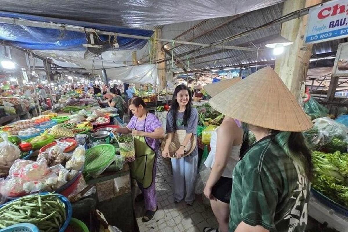 a group of women standing in a market with produce