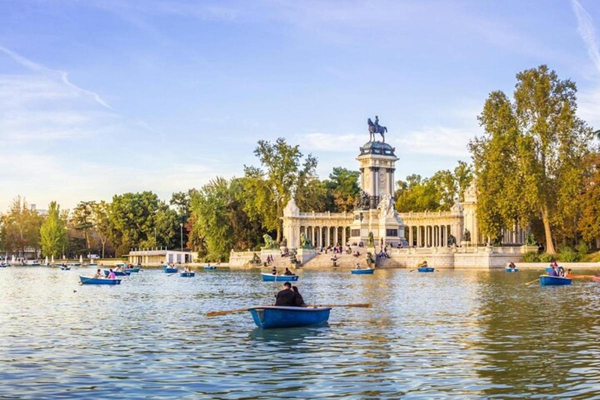 a group of people in boats in a lake with a statue