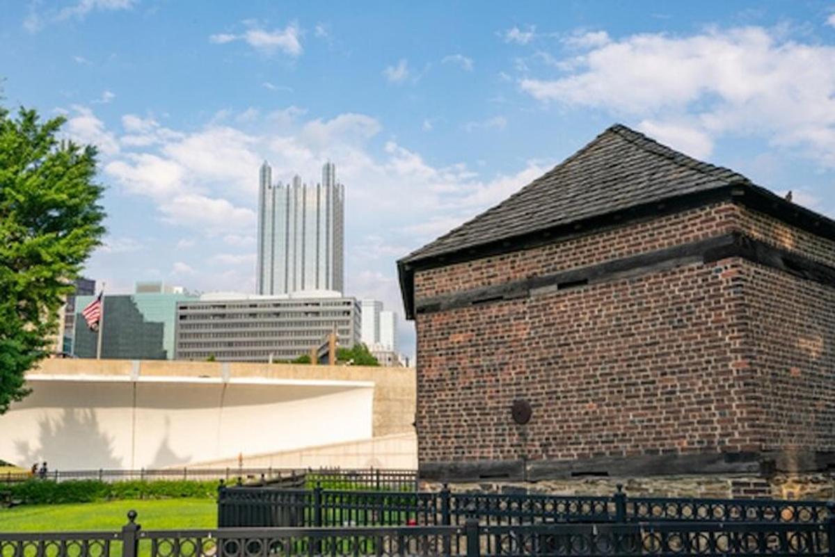 a brick building with a city in the background
