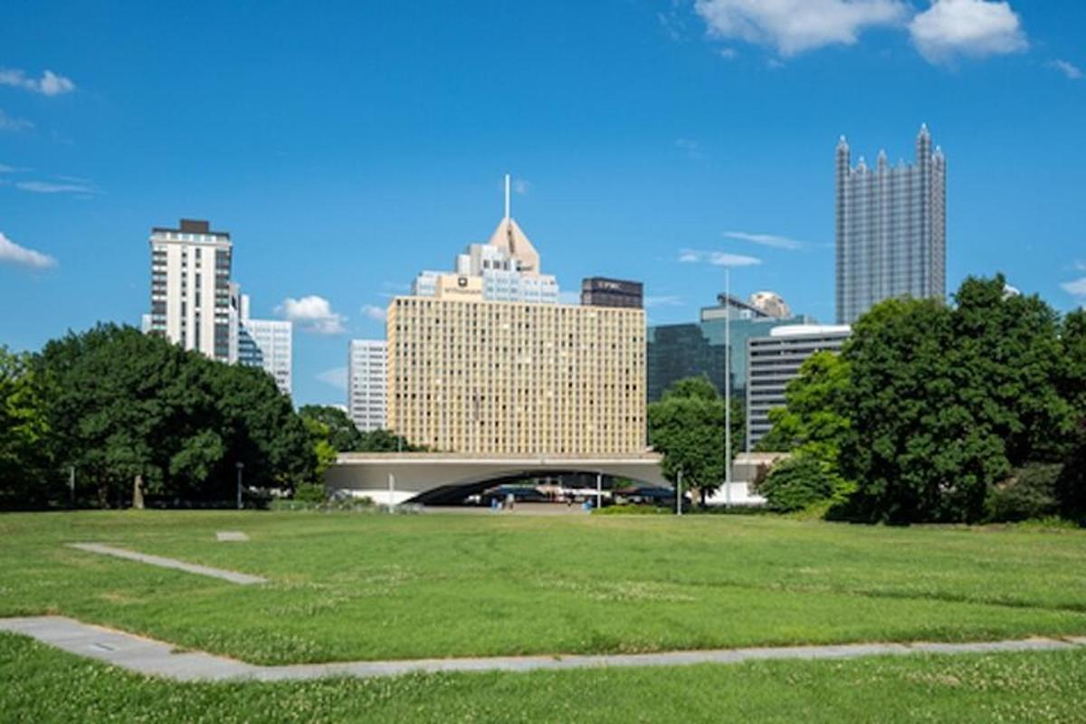 a view of a city with a park and buildings