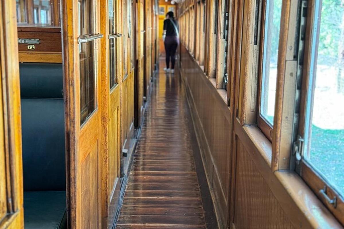 a person walking down a hallway on a train