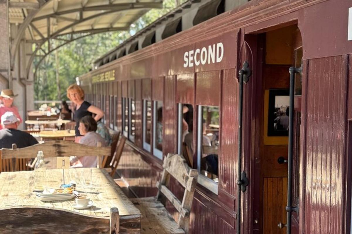 a train car with people sitting at tables in a restaurant