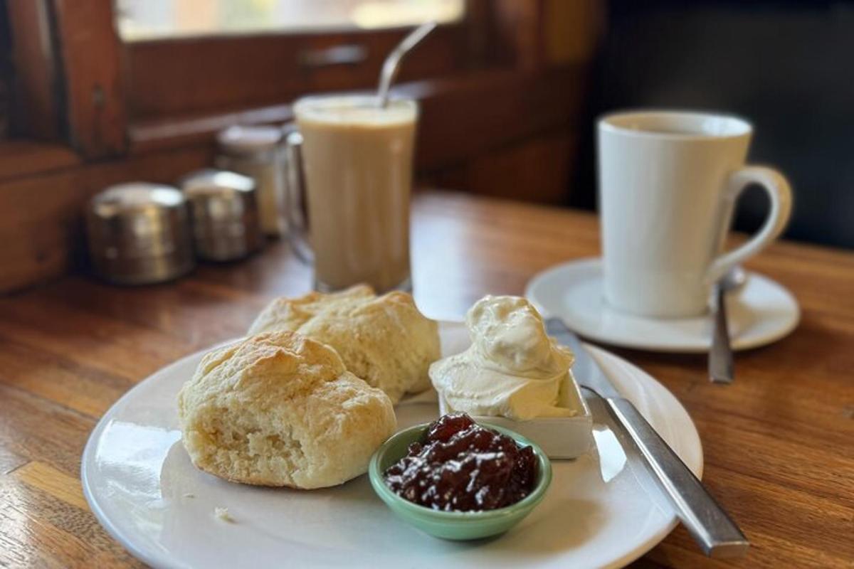 a white plate with two pastries and a cup of coffee