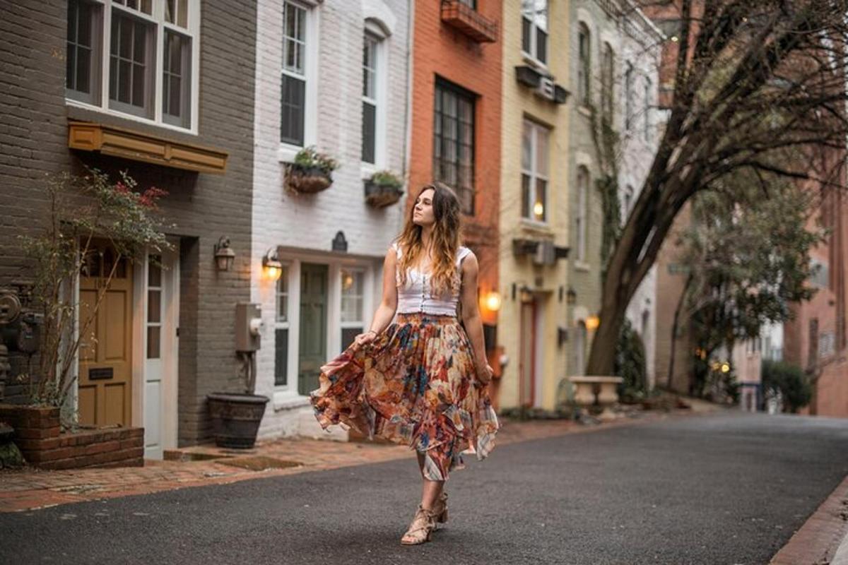 a woman in a dress walking down a street