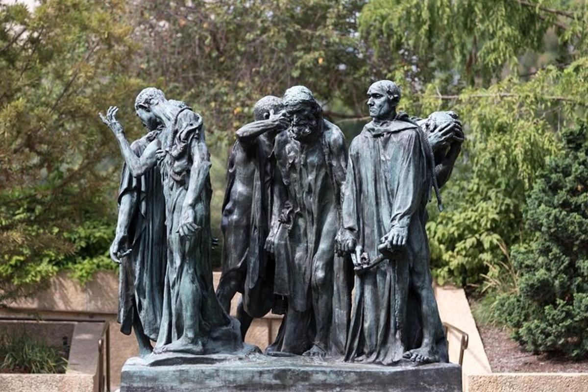 a statue of a group of people in a park