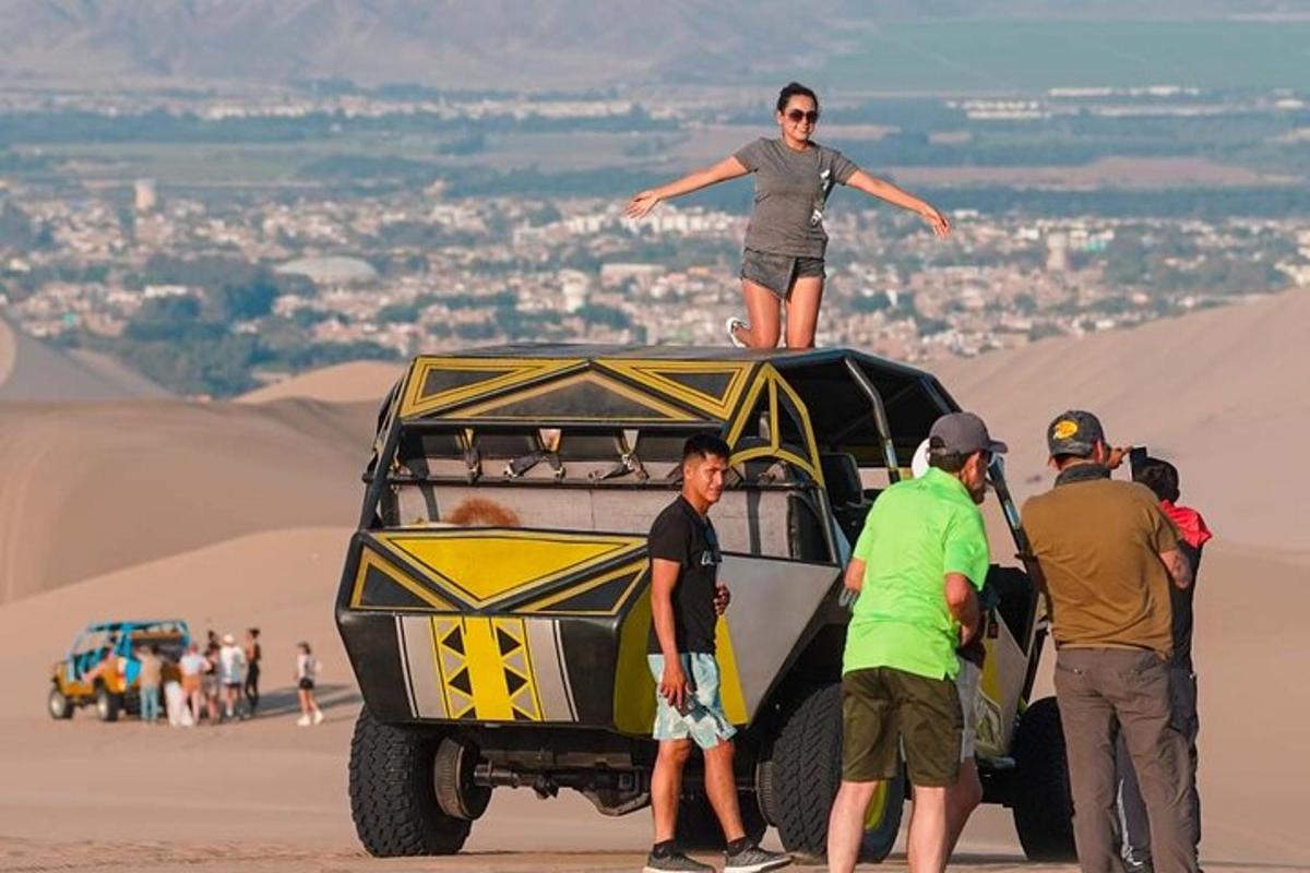 a woman standing on top of a jeep in the desert