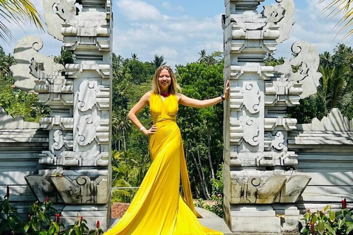 a woman in a yellow dress standing in front of a building