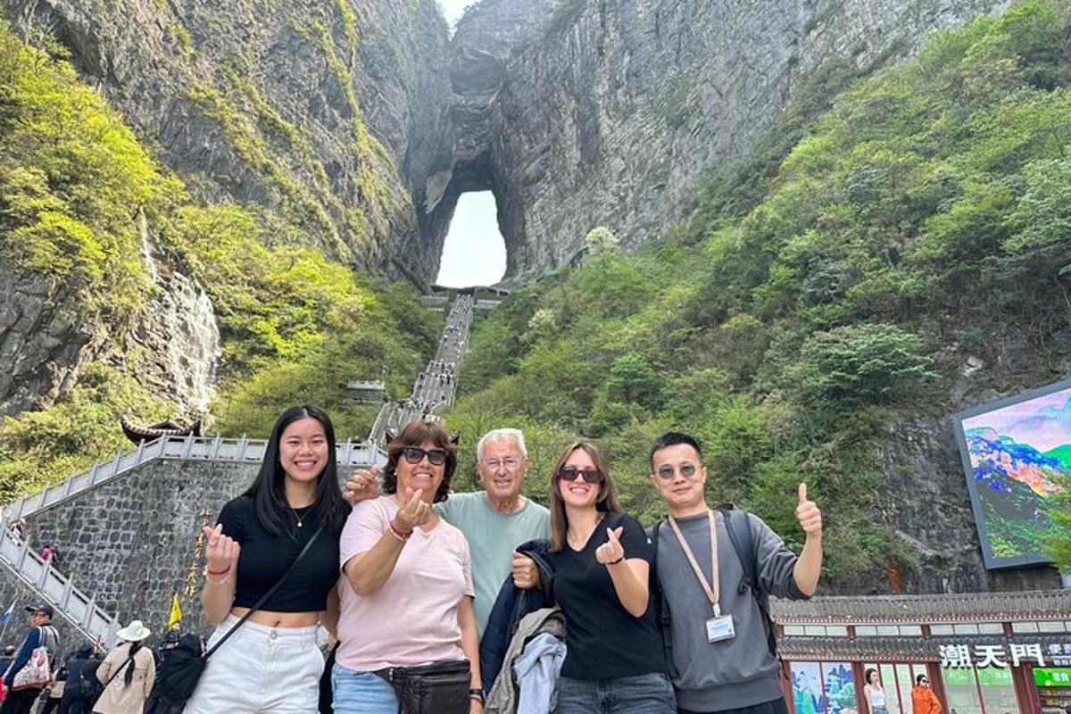 a group of people posing in front of a tunnel