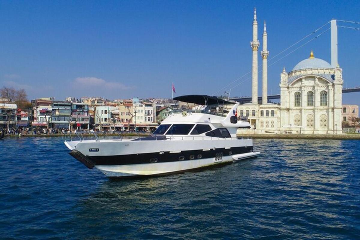 a white boat in the water in front of a building