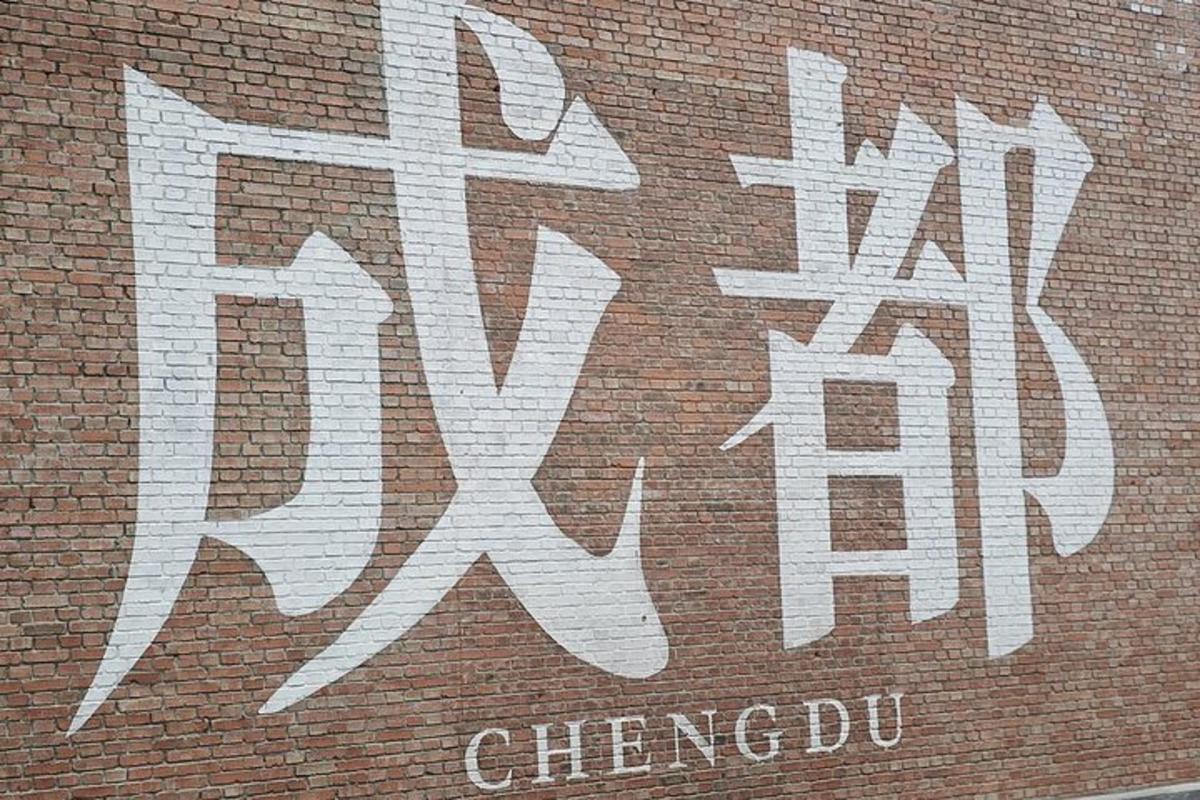a white graffiti on the side of a brick building