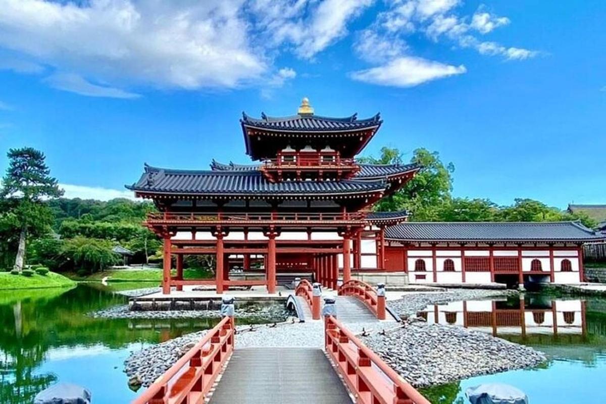 a large building with a bridge in front of a lake