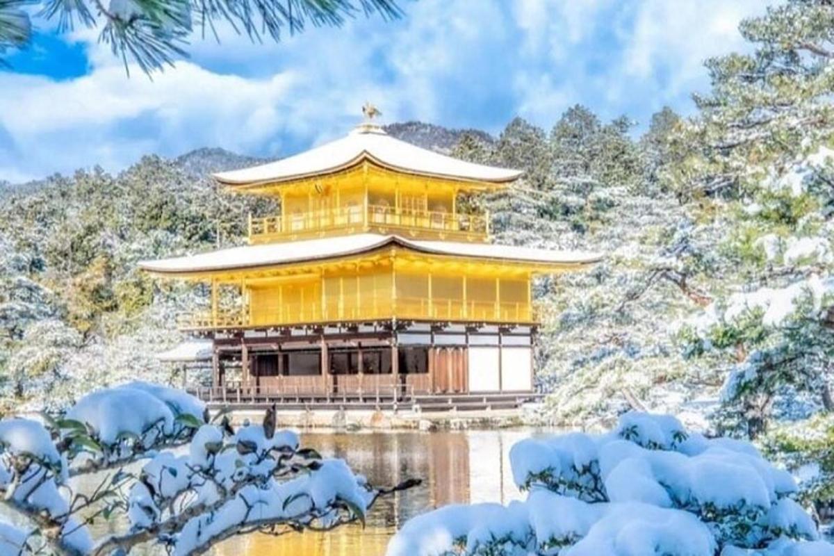 a temple in the snow with snow covered trees