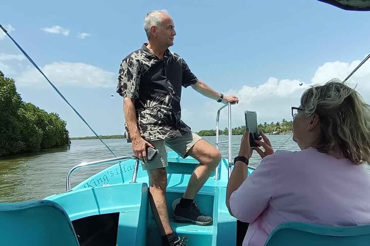 a woman taking a picture of a man on a boat