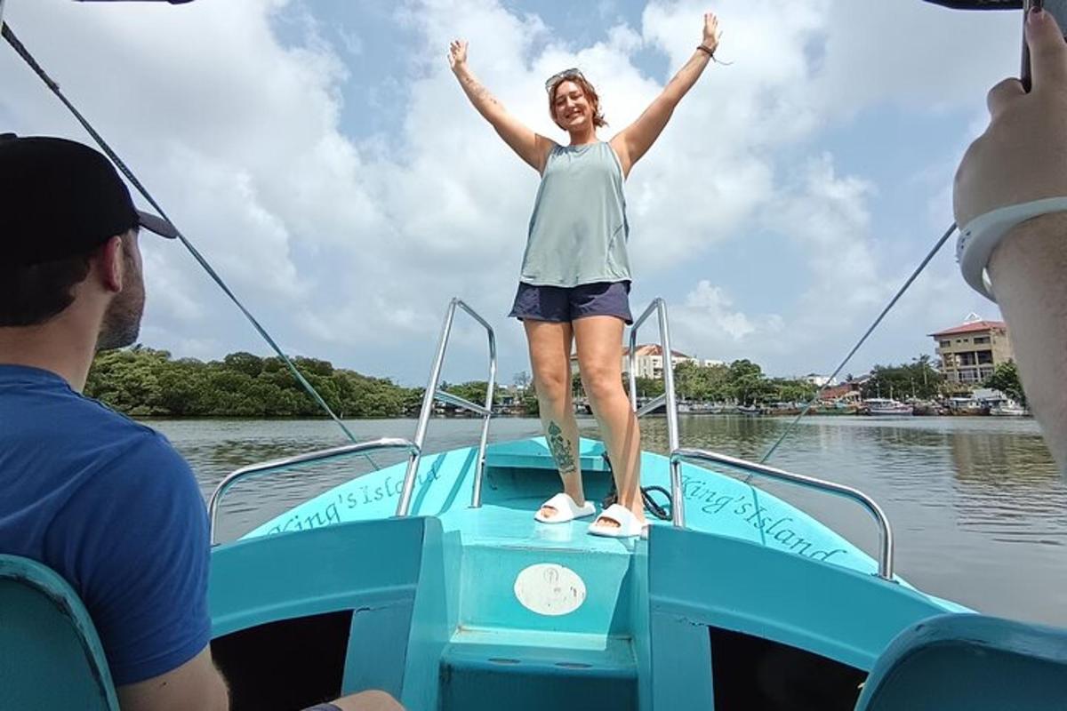 a woman standing on the front of a boat