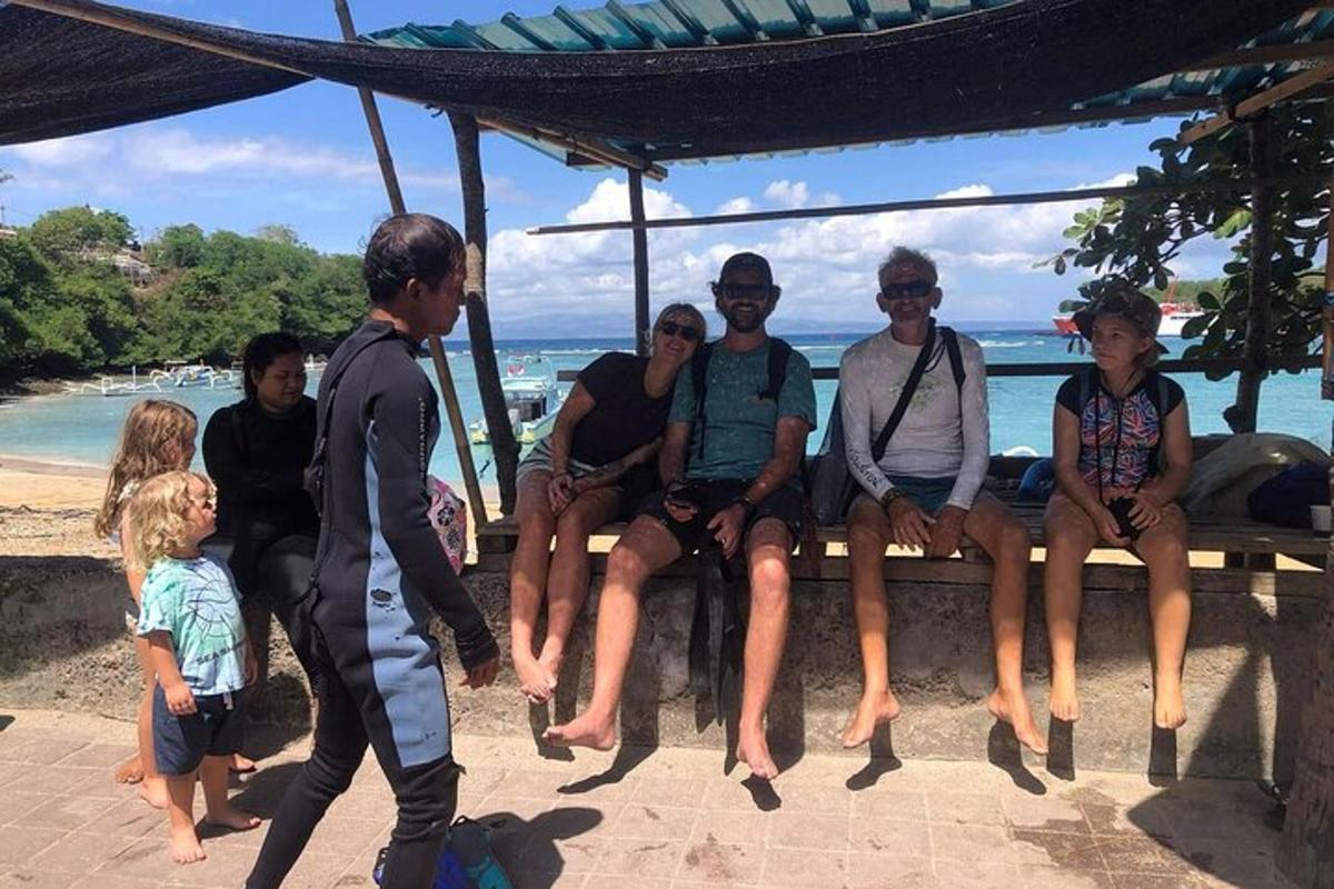 a group of people sitting on a bench at the beach