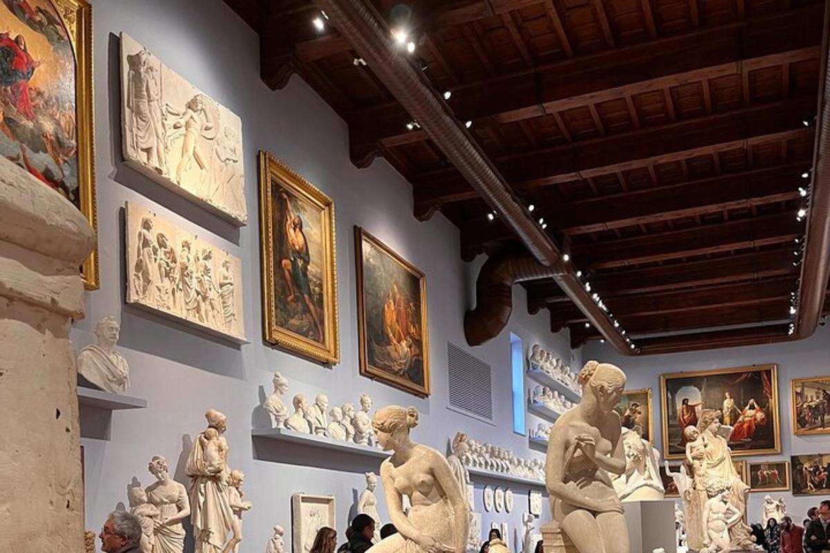 a museum with statues and pictures on a wall