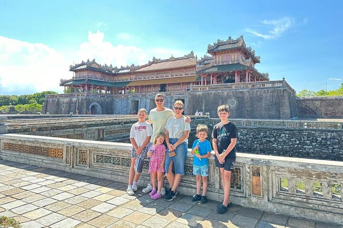 một gia đình đang tạo dáng chụp ảnh trước một tòa nhà