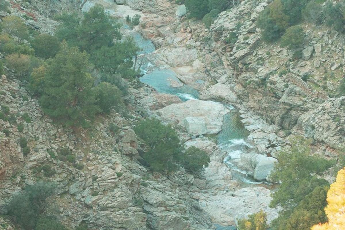 an aerial view of a river on a rocky mountain