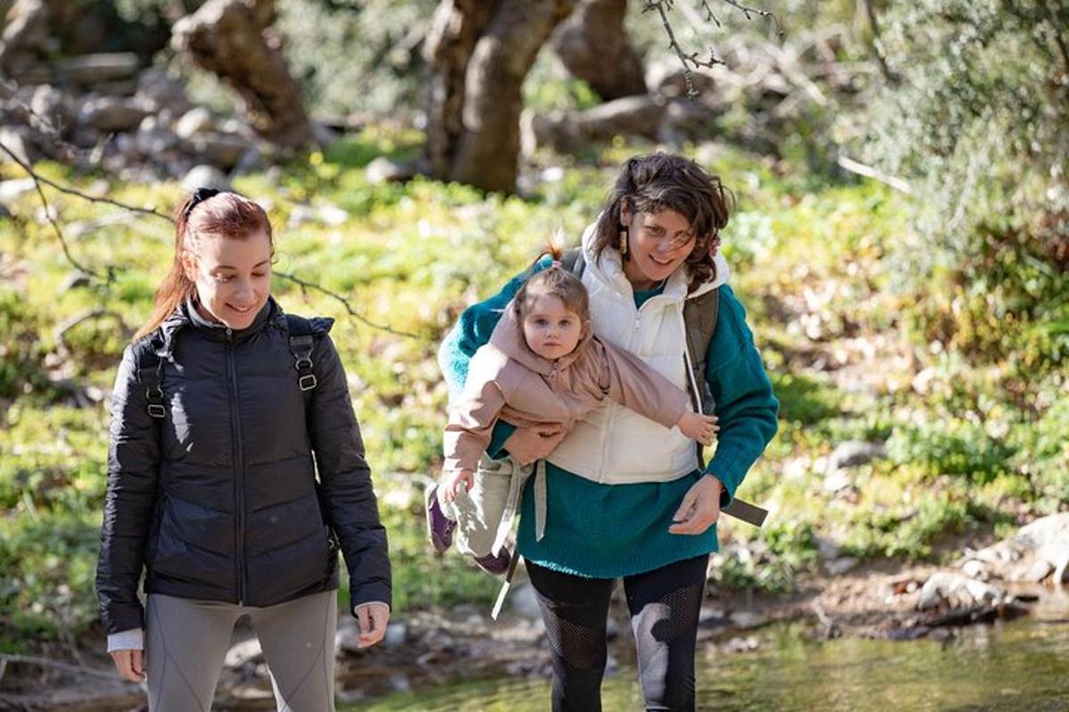 two women and a child walking through a stream