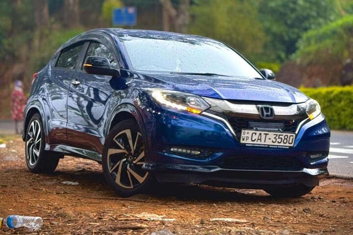 a blue car parked on a dirt road