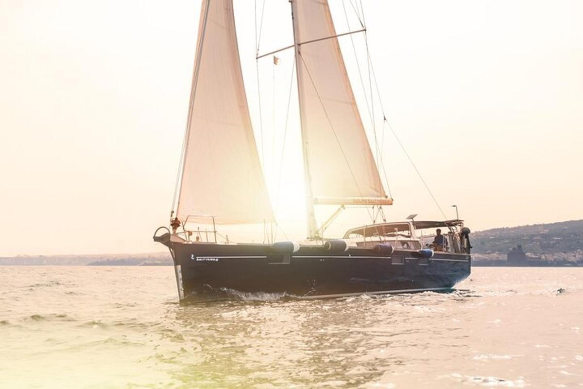 a sailboat in the water with people on it