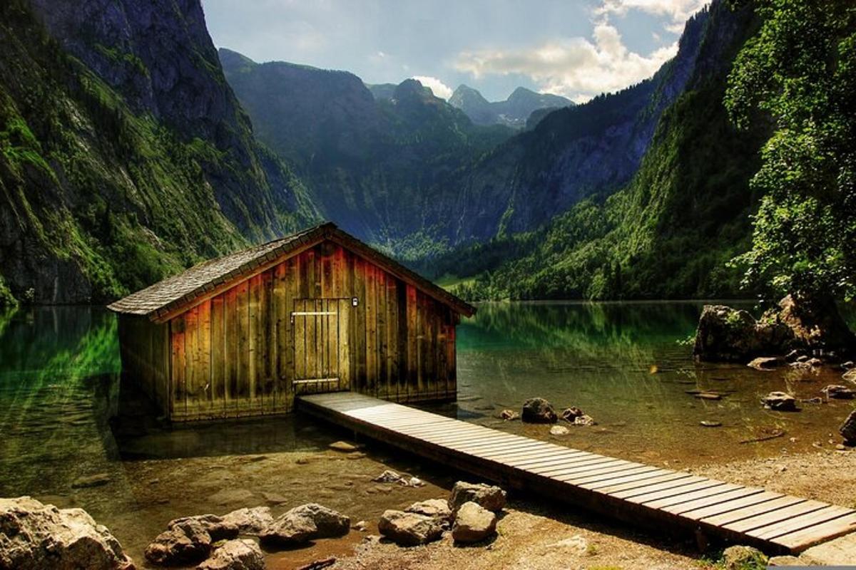 a small wooden building in the middle of a lake