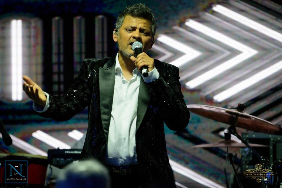a man singing into a microphone on a stage