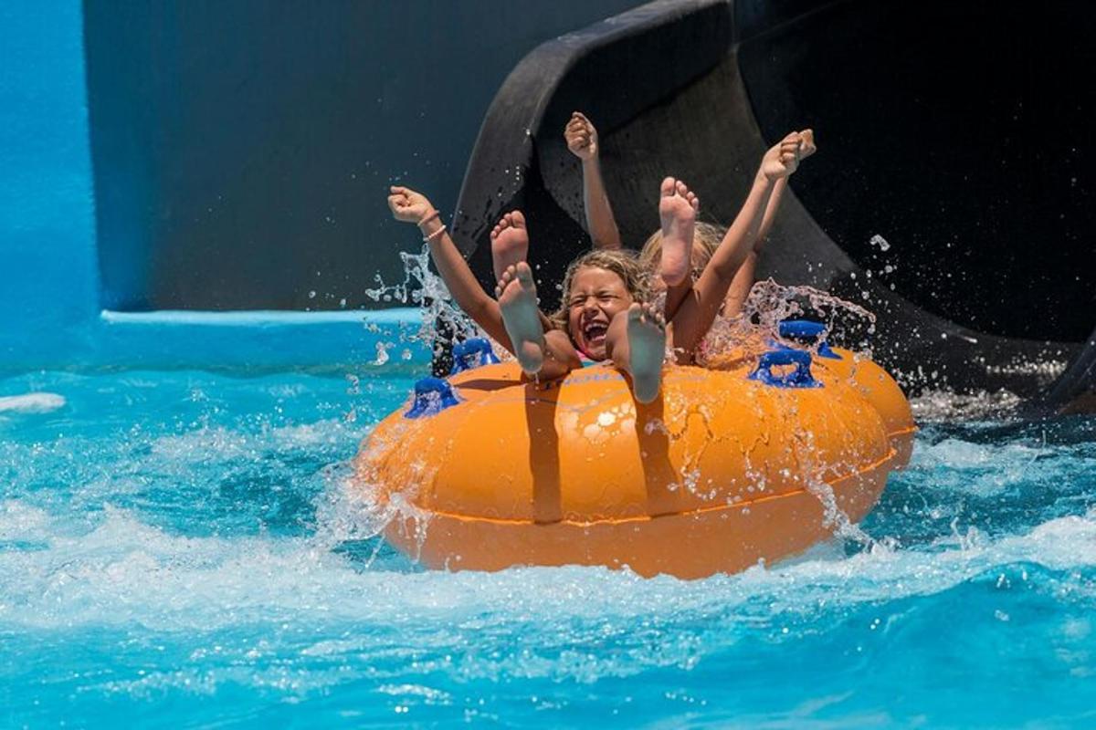 two children on an orange raft in the water