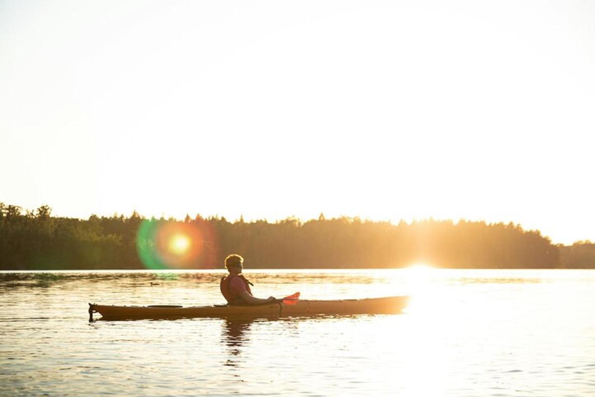 a man sitting in a canoe on a lake