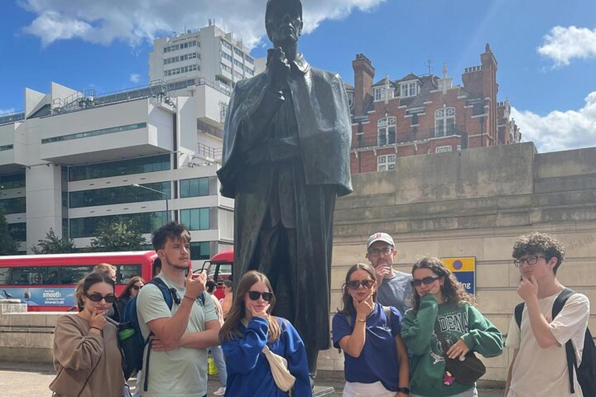 a group of people standing in front of a statue