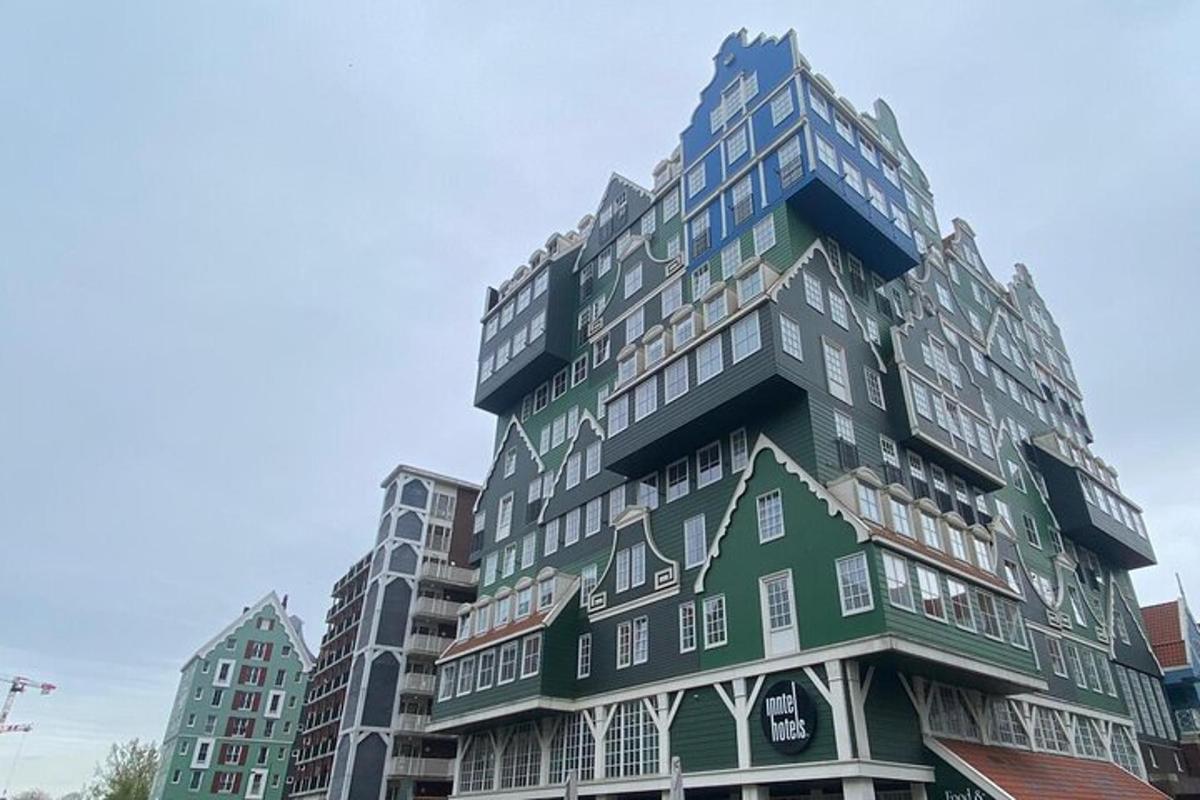 a tall green building with white windows