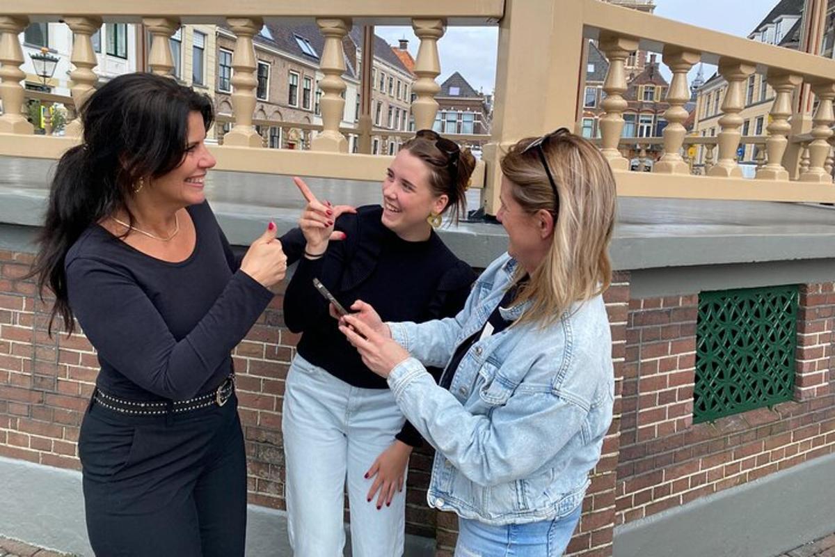 three women standing next to each other looking at their cell phones