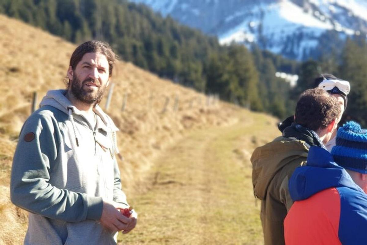 a man standing on a hill with two other people