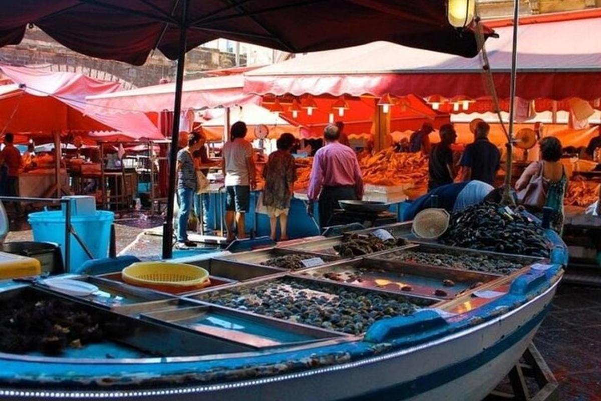 isang grupo ng mga tao na nakatayo sa paligid ng isang palengke na may bangka
