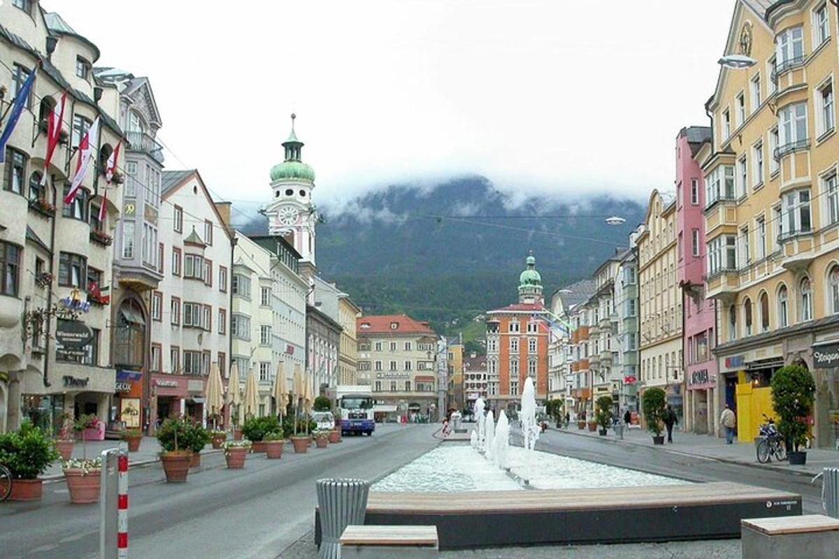 a city with a fountain in the middle of a street