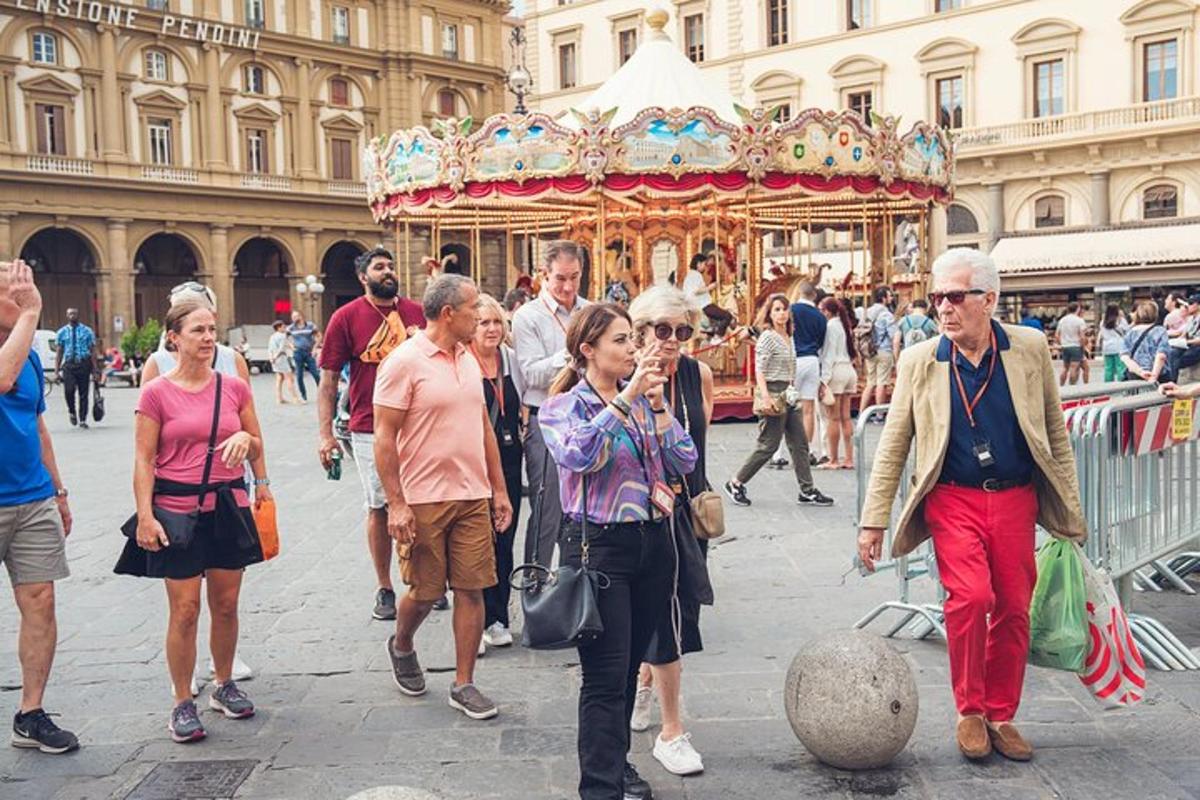 cilvēku grupa, kas iet karuseļa priekšā