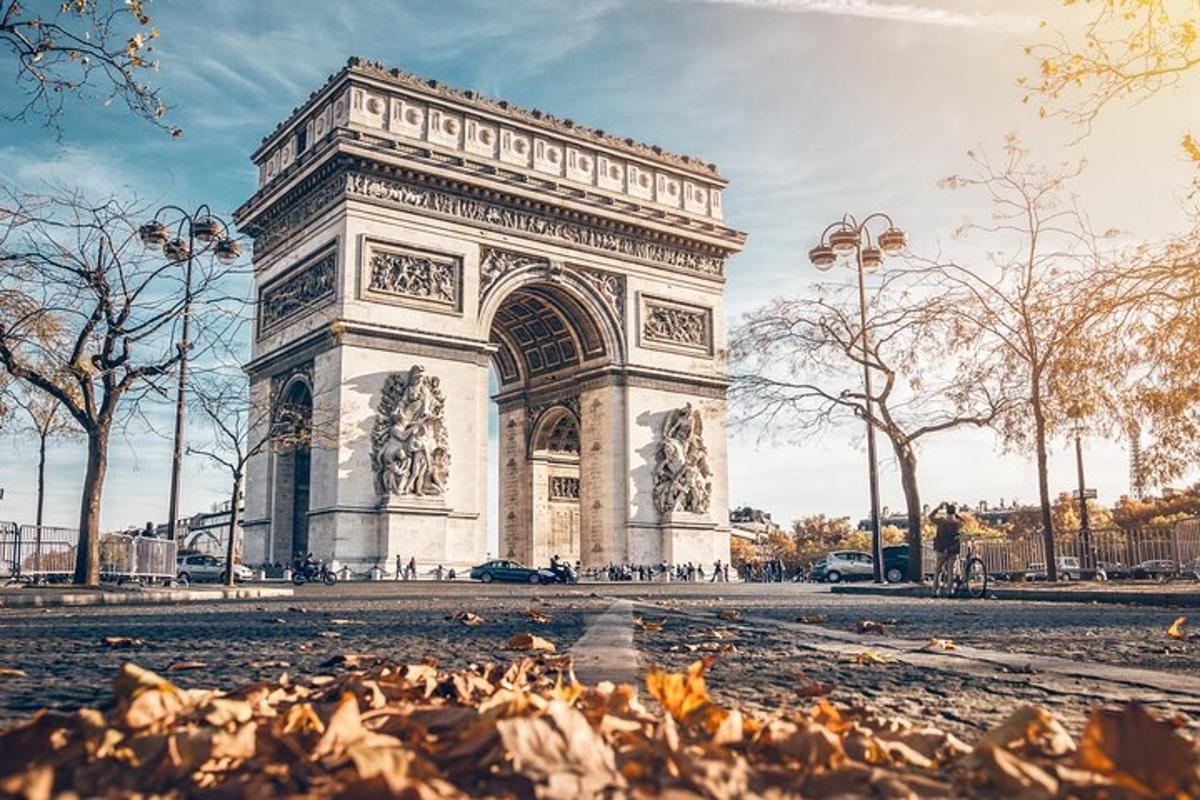 a monument in a park with leaves in front of it